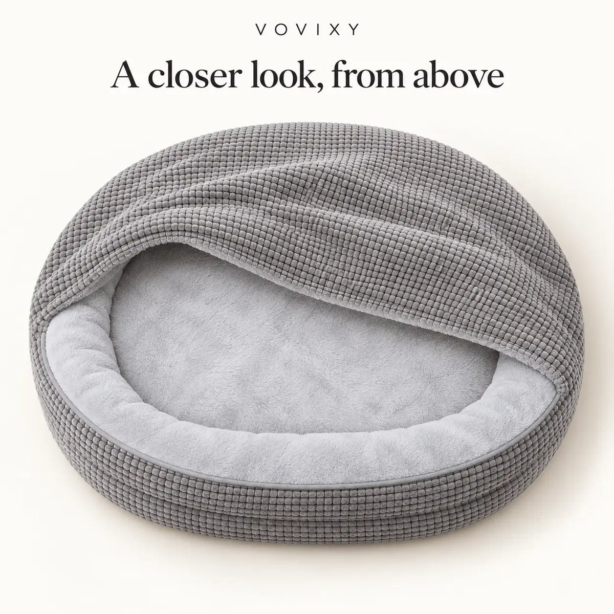 Overhead view of the Light Gray waffle hooded dog cave bed and plush sleeping area
