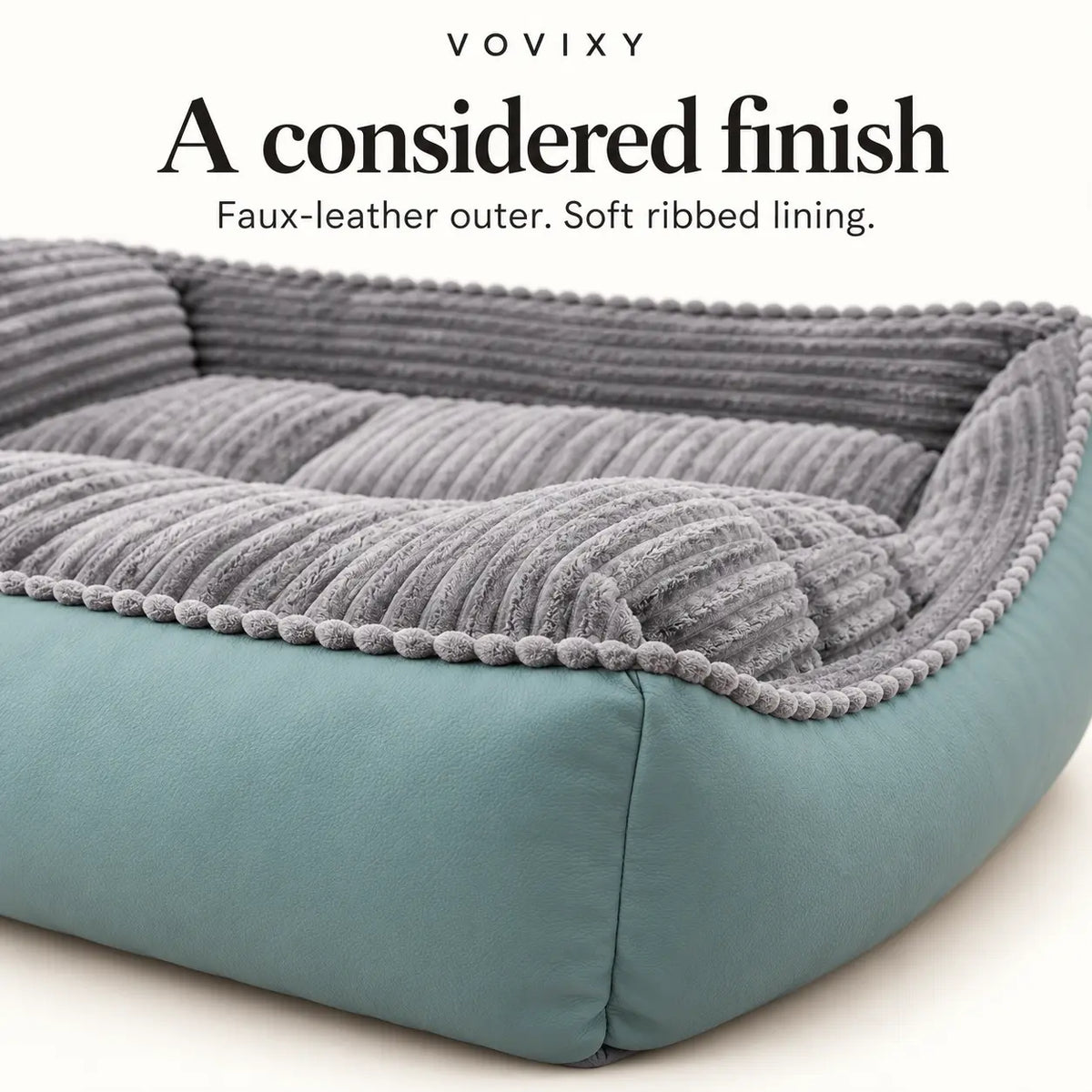 Close-up of seafoam faux-leather outer panels and grey ribbed velvet on the dog sofa bed