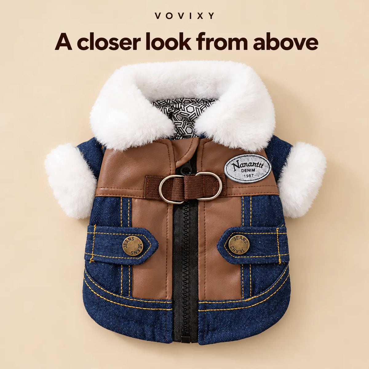 Overhead back view of the denim pet jacket with its white plush collar, double D-rings and back zip