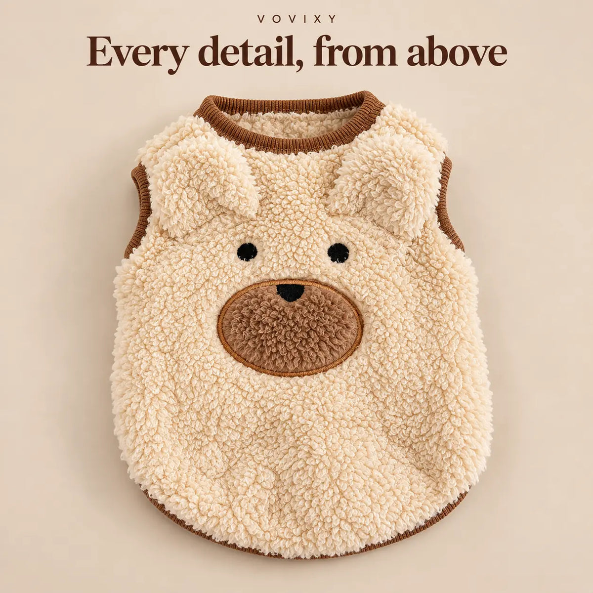 Flat lay of the Apricot teddy fleece dog vest with bear ears, a stitched face and a round neckline