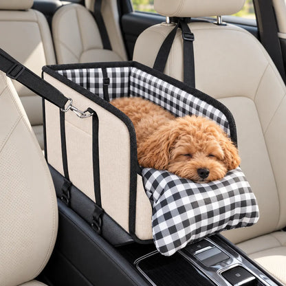 Small apricot dog resting in the beige console pet car seat with black-and-white plaid lining