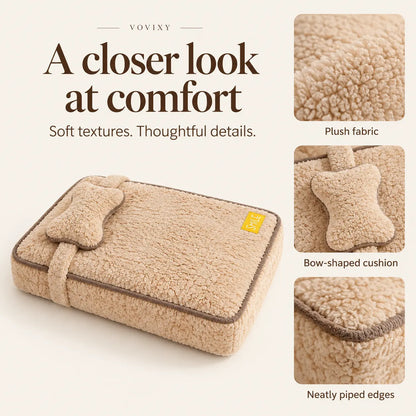 Beige plush pet bed showing the bow-shaped cushion, soft fabric and brown piped edges