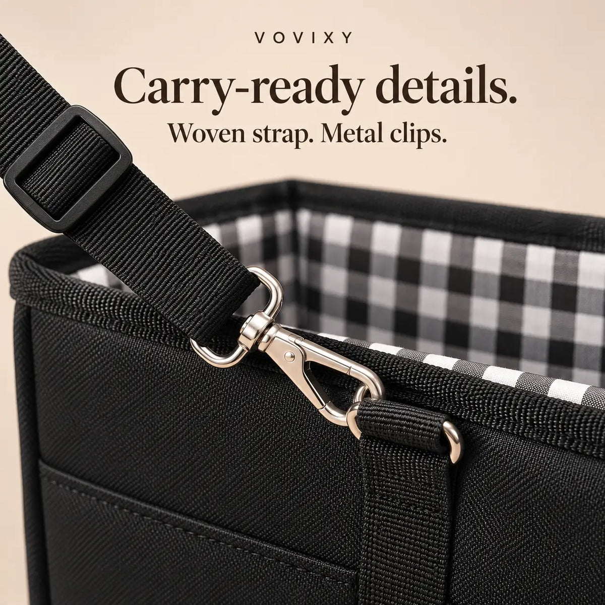 Adjustable black woven carrying strap with a metal snap clip attached to the pet car seat
