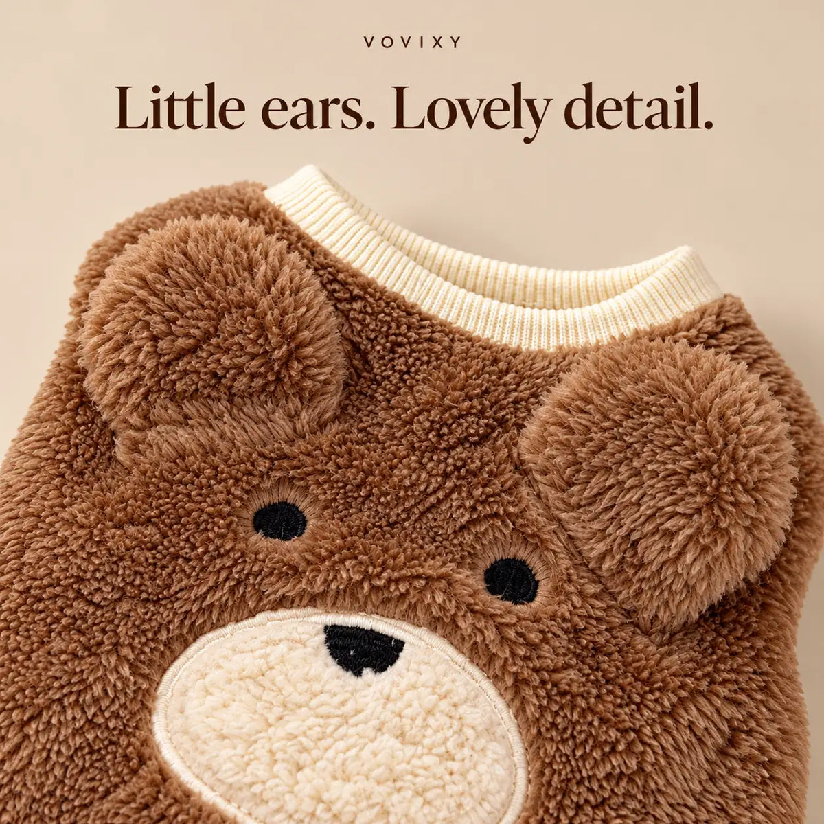Close-up of rounded bear ears and a stitched bear face on the Brown teddy fleece dog vest