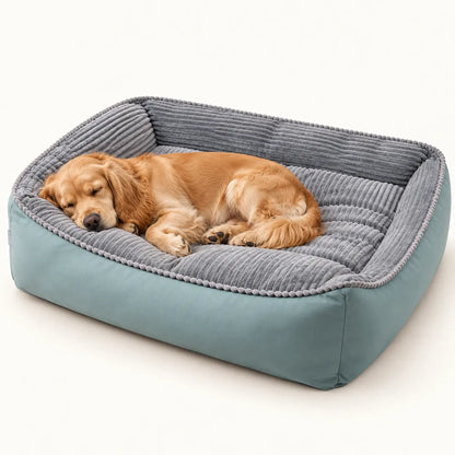 Golden Cocker Spaniel resting in a seafoam dog sofa bed with grey ribbed velvet and raised sides