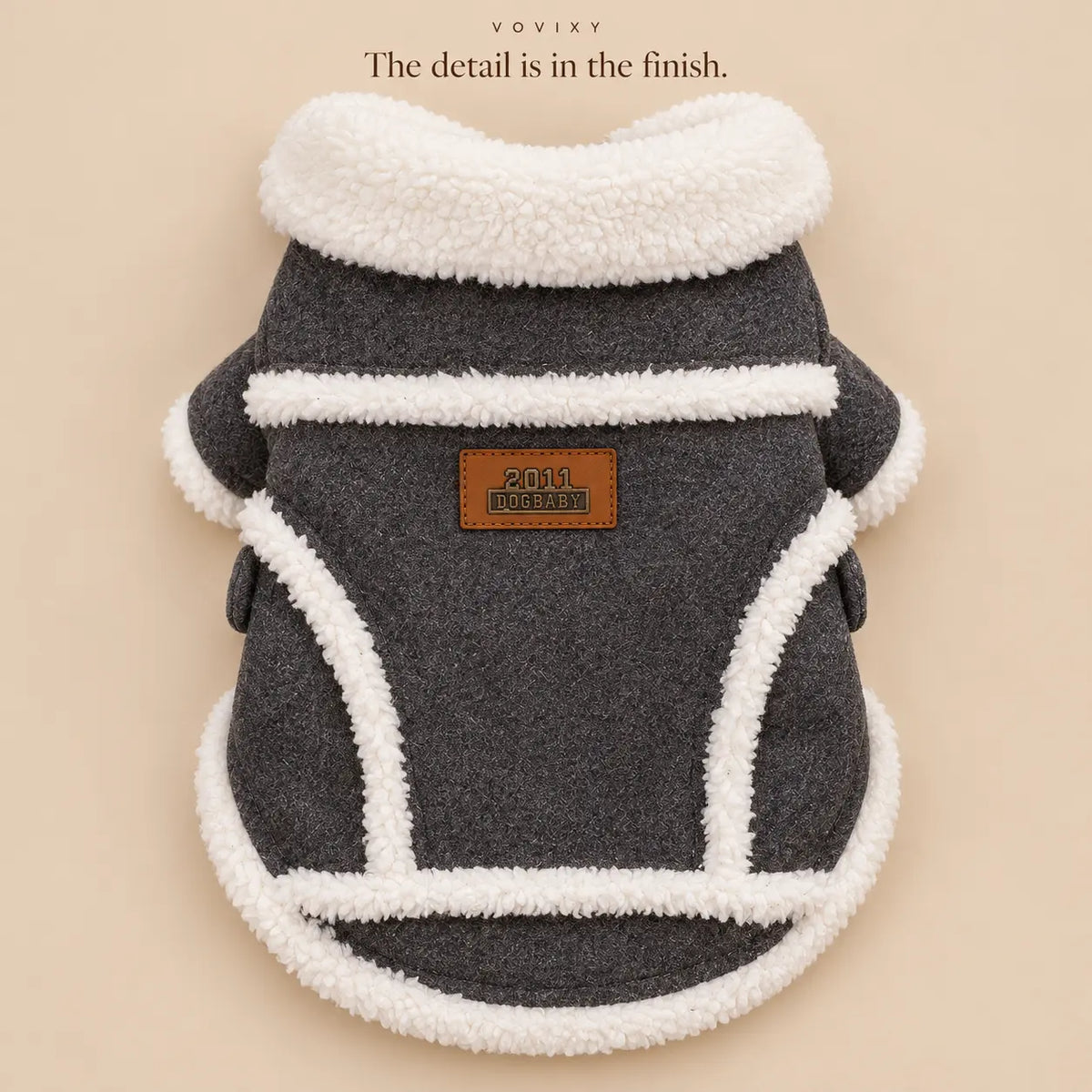 Rear detail of a Dark Grey dog coat with cream plush trim and a curved hem