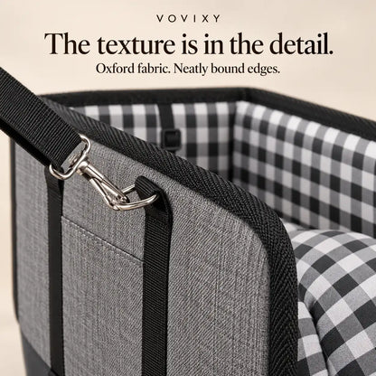 Close-up of the grey Oxford fabric exterior, black edge binding and metal strap clip