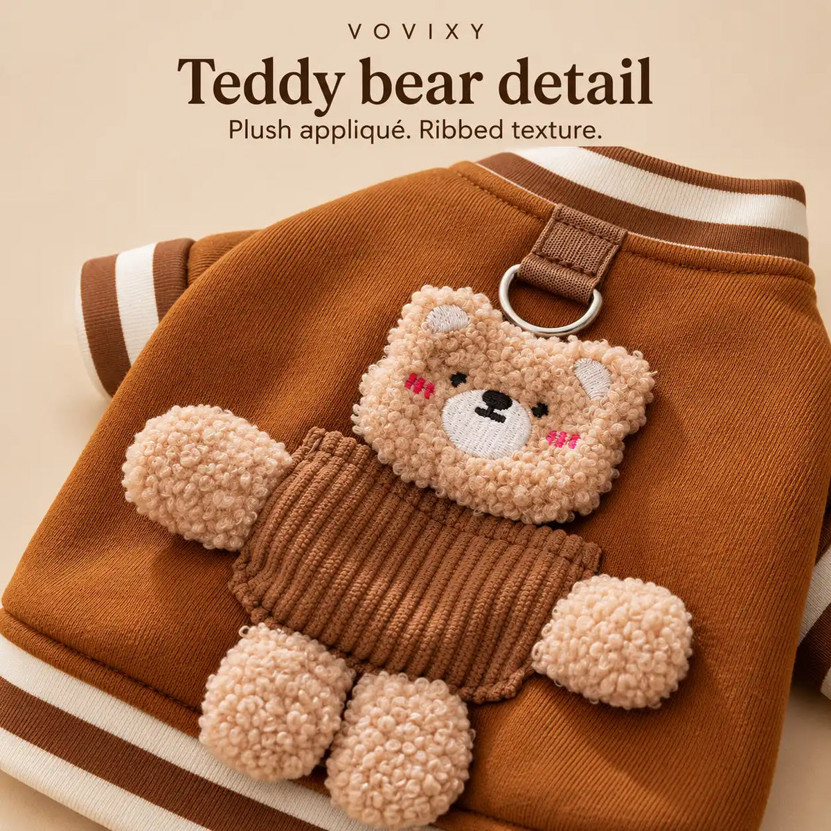 Close-up of the plush teddy bear appliqué and ribbed detail on a Brown Bear dog sweatshirt