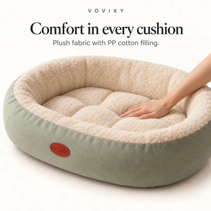 Sage Green bolster pet bed showing its soft cream lining and padded sleeping centre