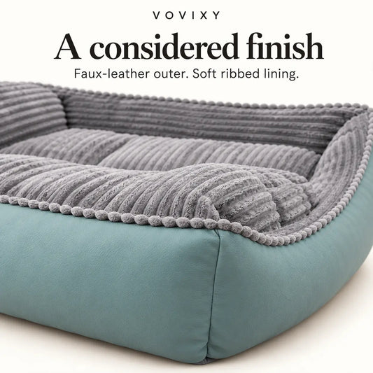 Close-up of seafoam faux-leather outer panels and grey ribbed velvet on the dog sofa bed